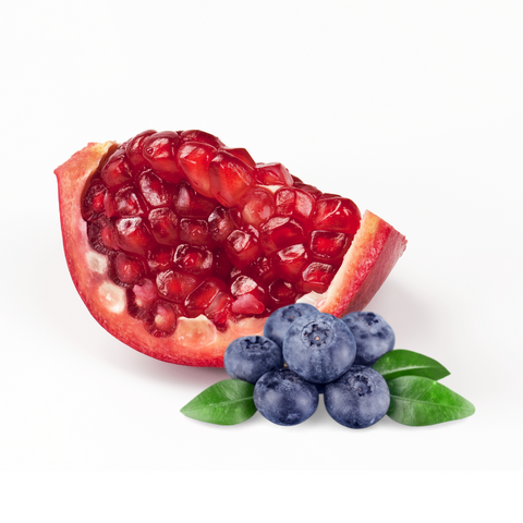 Pomegranate with seeds next to blueberries