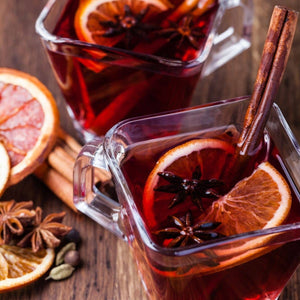 mulled spices with orange slices and cinnamon stick in glass mug