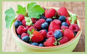 blueberries, strawberries and raspberries in a bowl
